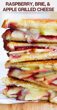 a stack of grilled sandwiches sitting on top of a wooden table