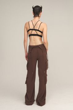 Relaxed fit cargo pant. Chain-shaped buttons and zipper closure to the front. Strappy waistband detachable with chain-shaped buttons. Low-rise without the detachable waistband. Mid-rise with the detachable waistband. 9 functional pockets through out front, side and back, with chain-shaped buttons or zippers closure. Pinched-lined tailoring. Folded cuff design at bottom ham. Model is 179cm (5'10), Wearing Size M. Body Color - Chocolate Brown Metal & Button Color - Silver. Fabric - 50% Cotton 46% Camp Brand, Cuff Design, Silver Fabric, Color Chocolate, Shopping Day, Cargo Pant, Body Color, Cargo Trousers, Body Colour