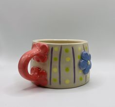 a ceramic cup with flowers on it