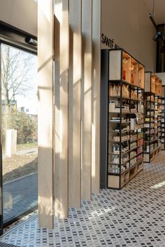 the inside of a store with shelves full of goods and boxes on display behind glass doors