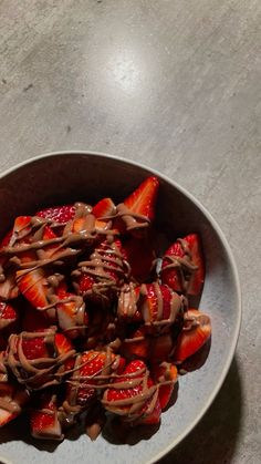 strawberries and chocolate in a bowl on a table