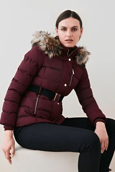 Women's Puffer Jacket In Ox Red With Fur Collar Make a bold winter statement with this women’s puffer jacket in ox red. Featuring a luxurious faux fur hood and belted waist, it offers both warmth and a figure-flattering fit. Crafted from 100% polyester with a soft viscose lining, it provides comfort and durability in colder weather. The turtle neck with hood adds extra coverage, while the zip-and-button closure ensures a secure fit. With two inner pockets, two side zip pockets, and a breast pock Fitted Puffer Jacket With Faux Fur Lining For Fall, Hooded Burgundy Outerwear For Winter, Hooded Burgundy Outerwear For Fall, Burgundy Hooded Outerwear For Winter, Trendy Puffer Jacket With Faux Fur Trim, Red Long Sleeve Puffer Jacket With Padded Collar, Red Outerwear With Faux Fur Trim For Cold Weather, Fitted Red Puffer Jacket For Winter, Red Fitted Outerwear With Faux Fur Trim