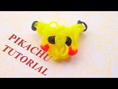 a yellow and red plastic toy bear sitting on top of a white table next to the words pikachu