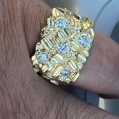 Mens real solid 925 silver nugget ring. 14K gold plated over 925 sterling silver. Stamped "925" on inside of ring band. Available in sizes 7, 8, 9, 10, 11, 12, 13. Stamped on the inside of the band "925". Diamond cuts on the rectangular nugget. Five man made round-cut stones shine hard. Solid pieces weigh 9 to 11 grams each. Genuine solid 925 silver, not cheap metal. Real ring that won't turn your fingers green. Beautiful rings that are jewelry masterpieces. Choose ring from pinky size 7 to size Gold Iced Out Diamond Ring As A Gift, Gold Iced Out Diamond Ring Gift, Yellow Gold Iced Out Jewelry Ring, Iced Out Gold Rings For Gift, Gold Hallmarked Cubic Zirconia Signet Ring, Hallmarked Gold Signet Ring With Cubic Zirconia, Gold Bling Ring Jewelry, Gold Cubic Zirconia Hallmarked Signet Ring, Gold Cluster Ring With Diamond Cut Cubic Zirconia