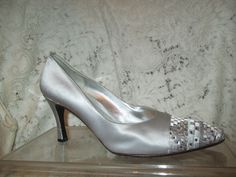 Stunning silver evening pumps. Size 7 1/2. Fabric uppers. Leather lining and sole.  3 1/4" covered heel.  The toes are embroidered in a geometric design in pewter, silver and white with sparkly square rhinestones. They have been worn once or twice and have a few light surface scuffs. Light sole wear. The inside heel area shows some darkening also the foot bead shows some wear.  I ship same or next business day. Fitted Silver Wedding Shoes With 4-inch Heel, Metallic Silver Pointed Toe Heels For Wedding, Fitted Silver Heels With Almond Toe, Fitted Silver Heels With Rhinestones, Elegant Heels With Silver Studs, Elegant Formal Heels With Silver Studs, Fitted Silver Embellished Heels, Elegant Metallic Silver Fitted Heels, Gray Fitted Heels For Evening