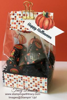 a halloween treat bag with candy in it and a happy halloween tag hanging from the top