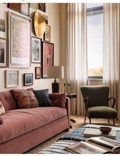 a living room filled with furniture and pictures on the wall