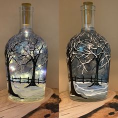 two glass vases with trees painted on them