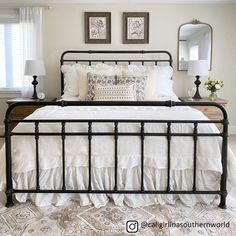 a bed with white sheets and pillows in a bedroom