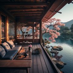 a wooden deck with couches and tables on it next to a body of water