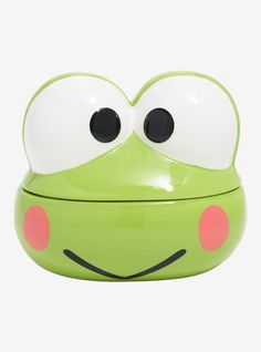 a green frog shaped container with eyes on it's face and tongue sticking out