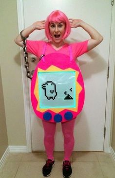 a woman dressed as a pink monster holding a sign