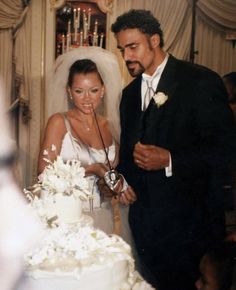 a bride and groom cutting their wedding cake