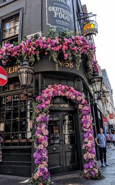 a tall building with flowers on the outside