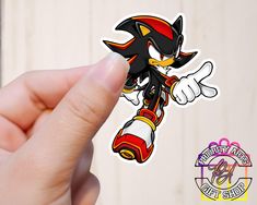 someone is holding up a sticker with an image of sonic the hedge