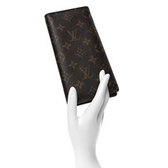 This is an authentic LOUIS VUITTON Monogram Brazza Wallet. This stylish vertical organizer wallet is crafted of Louis Vuitton monogram toile canvas. This opens to an interior of mocha cross-grain leather with card slots a zipper compartment, and patch pockets. Louis Vuitton Wallet, Wallet Organization, Authentic Louis Vuitton, Mocha, Louis Vuitton Monogram, Patch Pocket, Card Slots, Slots, Grain