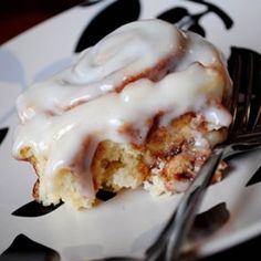 a close up of a plate of food with a fork on it and icing