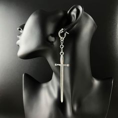 From your casual outfits to your most extravagant costumes, these original sword earrings will complete all your looks! Swords and emerald green rhinestones are paired in an elegant way to create this gothic, medieval fantasy style. With these big swords, these statement earrings will for sure catch all attention during your future adventures! Perfect for a gothic or medieval fantasy look, they will also be a great addition to your LARP and cosplay outfits. These earrings are comfortable with their stainless steel hypoallergenic hoop closures. DIMENSIONS AND WEIGHT: Each earring is 12 cm (4.72 in) long, including the hoop closure, and 2.3 cm (0.78 in) wide. Even if they are big, these earrings are light: each earring weighs 6.71 grams. Care instructions: The closures and rhinestones are ma Edgy Metal Jewelry For Cosplay, Punk Metal Jewelry For Fantasy Events, Silver Metal Earrings For Cosplay, Silver Pierced Earrings For Cosplay, Silver Earrings For Cosplay, Medieval Metal Jewelry, Medieval Style Metal Jewelry For Fantasy Events, Medieval Cross Metal Jewelry, Extravagant Costumes