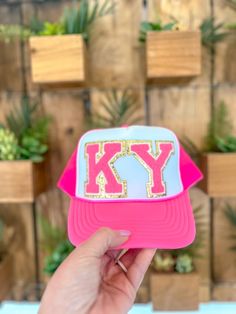 This KY Trucker Hat is the perfect way to stand out in any crowd. It features a bright neon pink design that will make you stand out, and an adjustable strap and mesh back to ensure a comfortable fit. Get noticed in this fashionable and functional trucker hat. Trendy Mesh Trucker Hat With Adjustable Fit, Trendy Adjustable Mesh Trucker Hat, Pink Visor Snapback Hat For Spring, Trendy Pink Adjustable Trucker Hat, Pink Snapback Hat For Sports In Spring, Trendy Trucker Hat For Spring Sports, Trendy Mesh Snapback Hat For Spring, Trendy Trucker Hat For Sports In Spring, Sporty Pink Hat For Spring