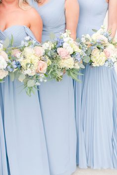 the bridesmaids are holding their bouquets together