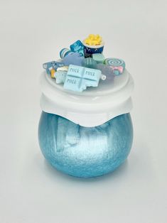 a blue and white container filled with baby items