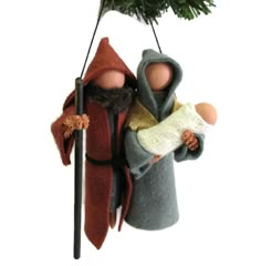 an ornament hanging from a christmas tree with two people dressed in medieval clothing