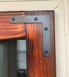 a close up of a wooden door with metal handles