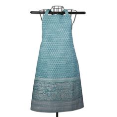 a dress on a mannequin with an ironing board in front of it