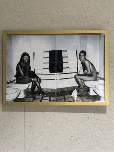 an old photo of two women sitting on toilets in a bathroom with the toilet seat up