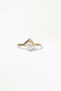 a yellow gold ring with a single diamond