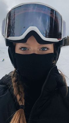 a woman wearing a ski mask and goggles