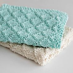 two crocheted dishcloths sitting on top of each other