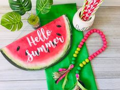 a watermelon slice with the word hello summer written on it next to other items