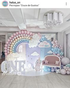 a room decorated with balloons, unicorns and clouds in pastel colors on the walls