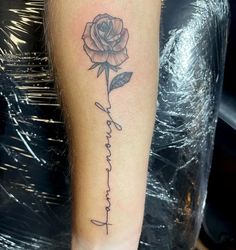 a rose with the word faith written in cursive writing on it's arm