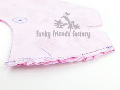 a piece of pink fabric with the words funky friends factory on it