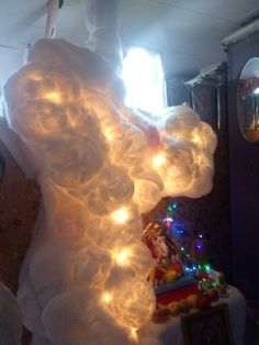 a large white cloud with christmas lights on it