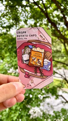 a hand holding up a sticker with the words crispe potato chips on it