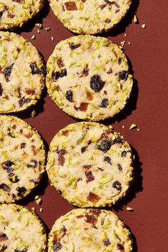 several cookies are arranged on a red surface