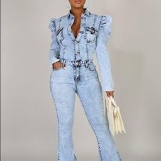 Denim Jumpsuit Features Ruffled Shoulder, Front Button Closure, Front And Back Pockets, Collard Neckline, Wide Leg , 34" Inseam, Stone Wash Denim, Stretch Denim Ruffle Sleeves Structured Waistband Flare Pant Legs Denim Fabrication Fabric: 98% Cotton 2% Spandex Fitted Denim Jeans With Ruffles, Fitted Ruffled Denim Jeans, Chic Medium Wash Denim Jumpsuit With Long Sleeves, Light Wash Fitted Denim Jumpsuit Button-up, Fitted Light Wash Denim Jumpsuit With Button-up, Fitted Light Wash Denim Button-up Jumpsuit, Light Wash Fitted Button-up Denim Jumpsuit, Denim Jumpsuits And Rompers With Ruffles, Spring Denim Jumpsuits And Rompers With Ruffles