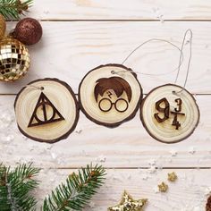 three wooden ornaments with harry potter symbols on them