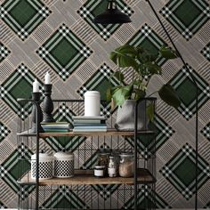 a shelf with some plants on it in front of a wallpapered background that is green and white