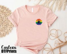 Proud Ally Sunflower Shirt, Rainbow Sunflower Pride T-shirt, LGBTQ+ Support Tee, Floral Pride Gift Tee, Ally Rainbow T-shirt, Flower Pride Flag Tee 🎈HOW TO ORDER 1-) Please, check and review all the photos. 2-) Choose your t-shirt size and color. *Different styles of shirts may have different shades of same color choice due to different manufacturer brands. *For this reason, we recommend you to match shirts from the same styles if you want precisely matching colors (ex. Unisex, V-necks, Toddler, etc.). 3-) Click add to cart. You can go back to add more shirts. 4-)Click "Proceed to check out". 5-)When you check out, you can add a note to seller for any request. 🎈PRODUCT DESCRIPTION UNISEX SHIRTS * Unisex t-shirt fits like a well-loved favorite, featuring a crew neck, and short sleeves, an Screen Print Crew Neck Tops For Pride, Crew Neck Top With Screen Print For Pride, Pink Crew Neck Top With Rainbow Print, Multicolor Cotton Shirt For Pride, Rainbow Graphic Print Shirt With Crew Neck, Rainbow Cotton Crew Neck Shirt, Cotton Crew Neck Shirt For Pride, Casual Pink T-shirt With Rainbow Print, Pride Rainbow Pre-shrunk Top