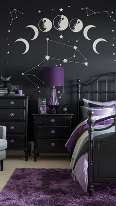 a bedroom decorated in black and purple with stars and moon decals on the wall