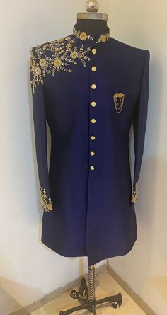 a blue suit with gold buttons on it