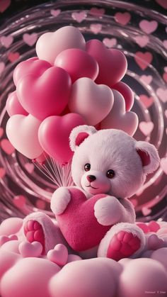 a white teddy bear sitting on top of pink heart shaped balloons in front of a glass bowl