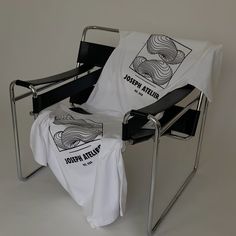 a chair with a white shirt on it and a towel hanging from the armrest