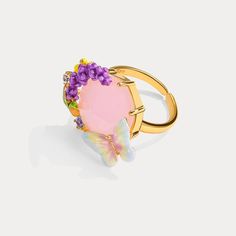 Indulge in the magical beauty of our Pink Crystal Lavender Butterfly Ring. With a stunning pink crystal at its center, surrounded by delicate lavender accents and butterfly motifs, this ring exudes love, romance, and an energy of tranquility. Dressing up your hand with such a bright and colorful floral ring will easily bring joy and energy to your look. Let it inspire you and add a touch of enchantment to any outfit. DETAILS Plating: 18K Gold Materials: 18K Gold on Brass, Enamel, Gemstones, Pear Luxury Lavender Rings For Gift, Pink Flower Ring For Spring Wedding, Spring Wedding Pink Flower Ring, Pink Amethyst Rings For Gift, Elegant Spring Jewelry With Butterfly Charm, Elegant Spring Butterfly Jewelry, Whimsical Purple Jewelry For Wedding, Whimsical Purple Wedding Jewelry, Pink Spring Anniversary Jewelry