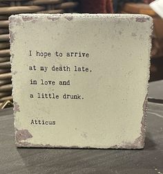 a stone block with a quote on it sitting on a table next to a basket