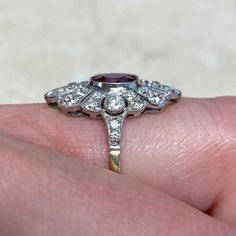 This ring inspired by the Art Deco era features a 1.52 carat oval cut ruby, bezel-set and surrounded by pave-set diamonds in a geometric design. Two additional accent diamonds are bezel-set on either side of the ruby, and the shoulders are pave-set with smaller stones. The total approximate weight of the diamonds is 1.00 carat. This ring is platinum on 18k yellow gold, and decorated with fine milgrain.
The measurements of the ruby are approximately 6.66mm x 5.42mm x 4.00mm.
This ring can be resi Luxury Ruby And Diamond Oval Cabochon Ring, Luxury Ruby Ring With Oval Cabochon Diamond, Luxury Oval Ruby Diamond Ring, Luxury Marquise Ruby Ring With Diamonds, Luxury Ruby Ring With Oval Center Stone, Luxury Oval Ruby Ring With Center Stone, Oval Ruby Ring With Platinum Band, Oval Ruby Ring With Platinum Setting, Oval Ruby Ring With Platinum Center Stone